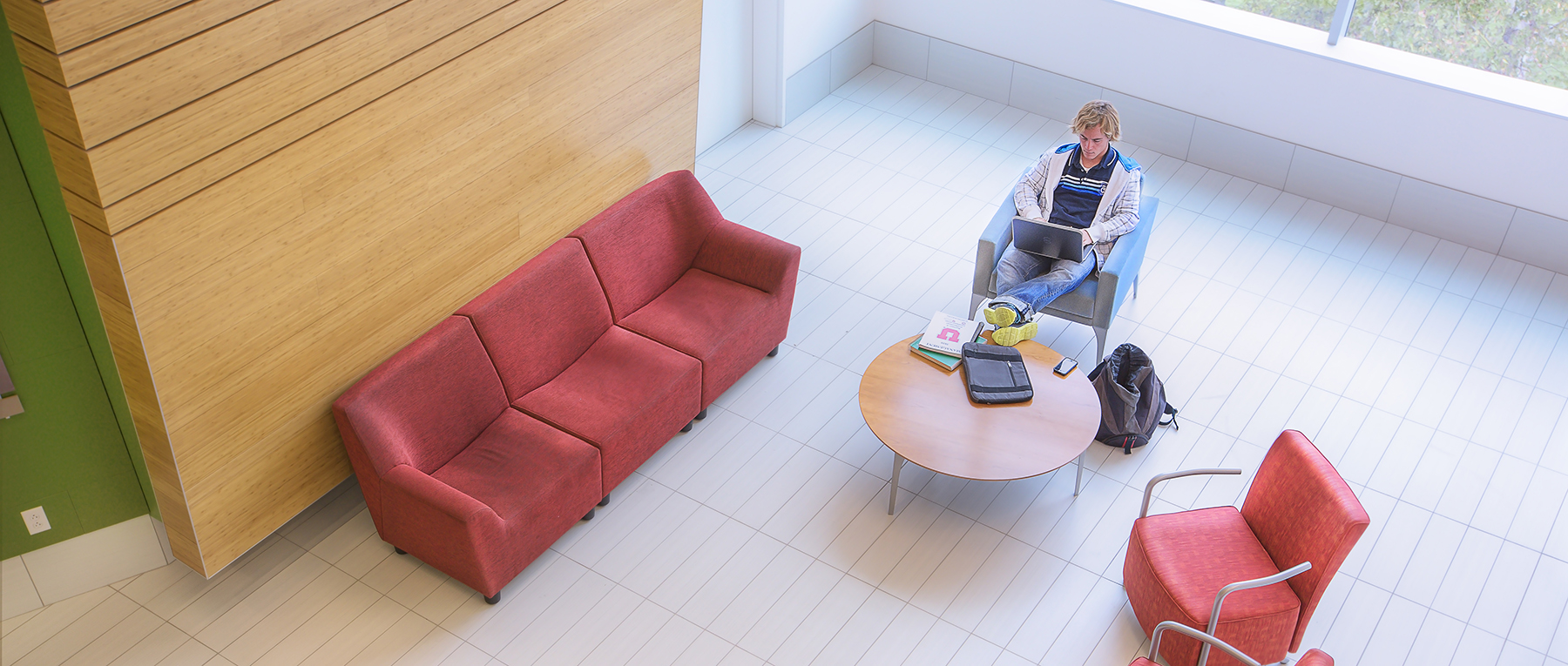 overhead photo of a studnet sitting in a lounge seating area